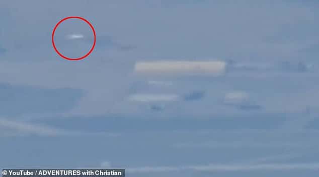 Mysterious white UFO is filmed hovering over Area 51 by hikers.