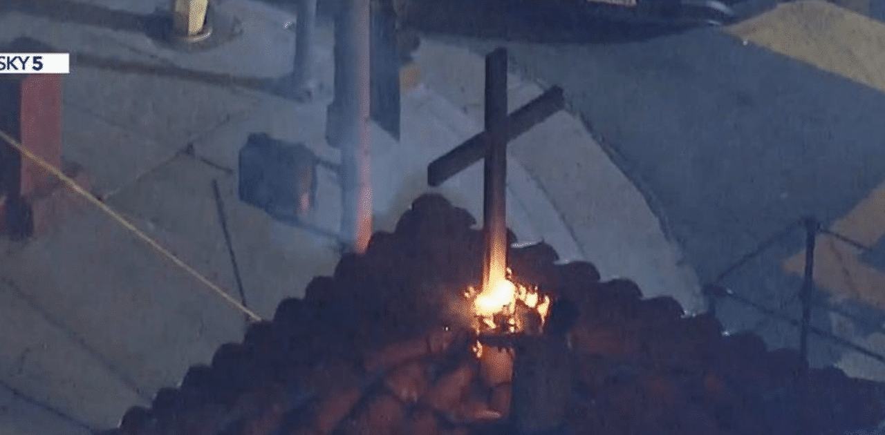 A man wearing nothing but his underwear scales church and sets fire to cross in California