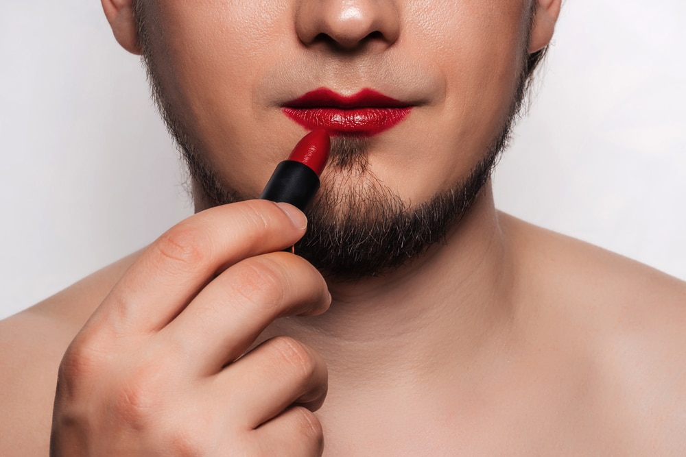 Woke makeup brand shares photo of bearded man wearing bright pink lip cream