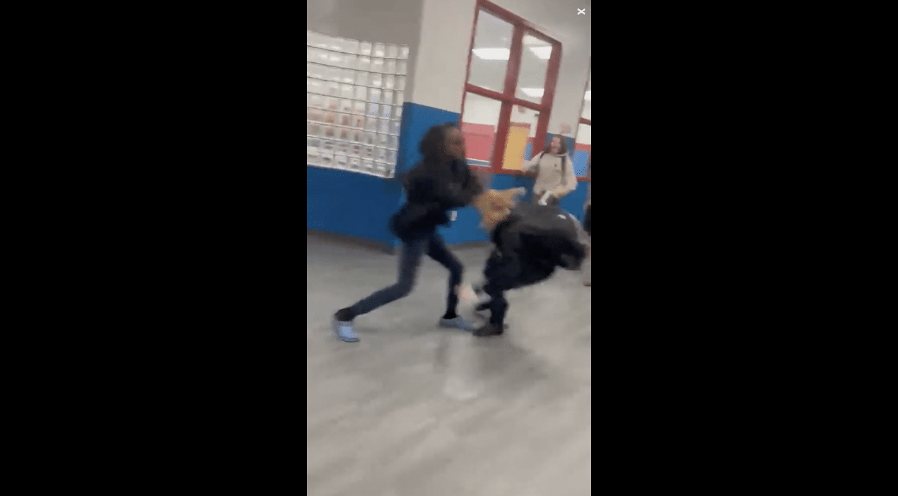 Middle School student drags fellow pupil to the ground and repeatedly bangs her head on the floor in front of crowd who are barking and cheering